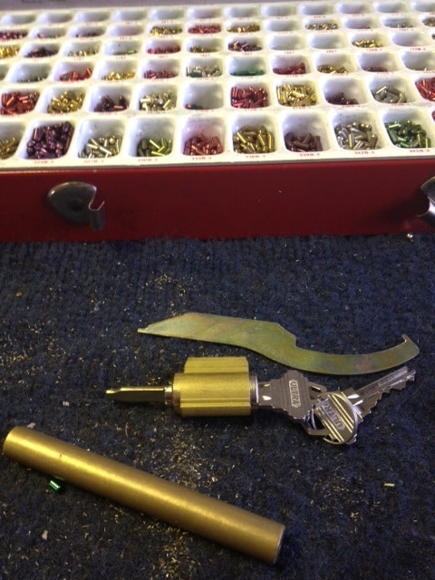 image of lock cylinder, lock rekeying tools and a box of lock cylinder pins